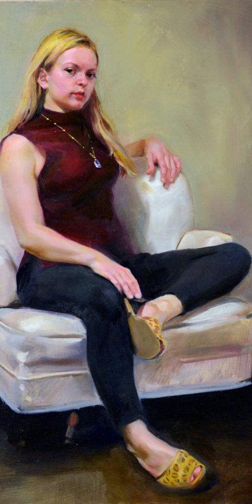 Figurative oil portrait of a young woman with blonde hair wearing a burgundy colored shirt. legging and leopard skin mules sitting in a white armchair