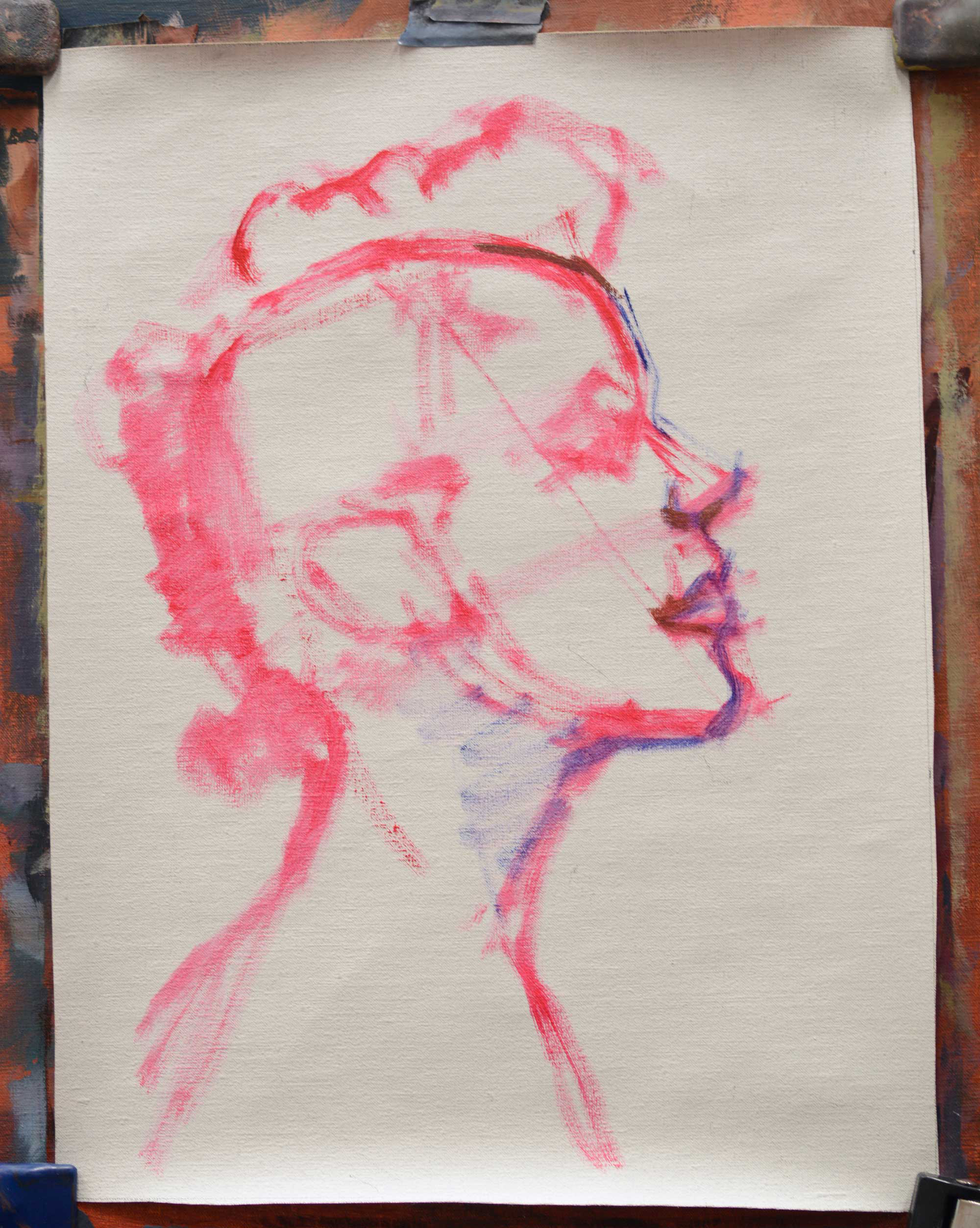 Artist canvas with rough sketch in a bright paint of a head in profile with more details added